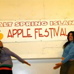 Volunteers Kayah and Deanna Ziraldo, show off one of our apple banners.